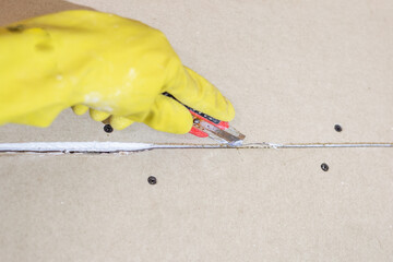 Preparing drywall for putty and plaster. The craftsman cuts the edge of the drywall at the joint...