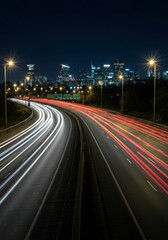 A smooth highway at night illuminated by vehicle light trails, creating a futuristic cityscape effect.

