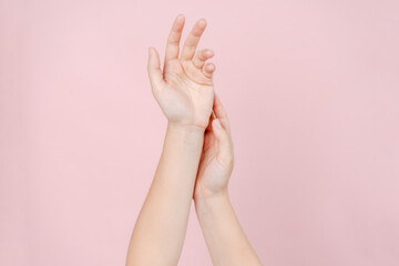 Manicured nails, beautiful woman hands forming an elegant shape on pink background