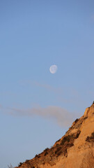 Scenic seascape with rock formations and a full moon