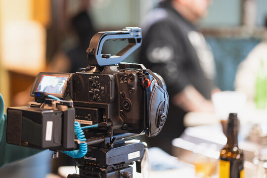 old movie camera on tripod - Powered by Adobe