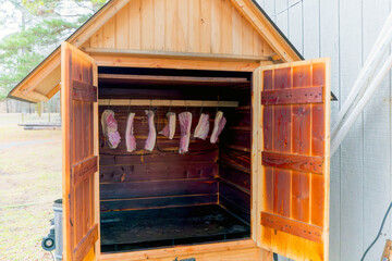 Smokehouse with prepared, hung meat for smoke