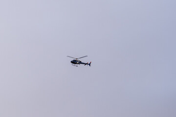 A helicopter is flying in the sky. A helicopter during flight.