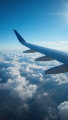 Fototapeta premium Passenger jet soaring above the clouds during takeoff, close-up on the wing with cityscape far below, under a vibrant blue sky Generative AI