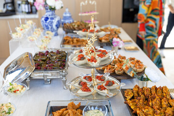 catering buffet with different food snacks and appetizers on table