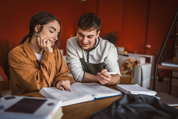 man student help his woman colleague to prepare exam and support her