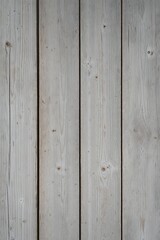 Naklejka premium a wooden surface, showcasing a vertical layout of four wide planks. The wood has a weathered and rustic appearance, with a predominantly light gray color, interspersed with subtle variations in tone. 