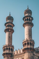 Fototapeta premium Twin minarets stand tall in this captivating islamic mosque architecture photography.