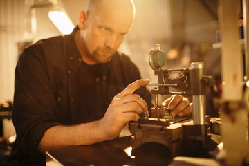 Middle aged caucasian mechanic working in a mechanics shop