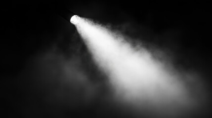 A bright flashlight beam cutting through darkness, revealing misty air around it, creating an enigmatic atmosphere.