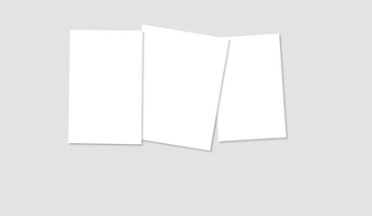 A realistic mockup featuring three blank white rectangular papers arranged in a slightly overlapping manner on a light gray background