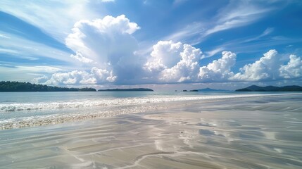 Obraz premium Serene beach landscape under a vibrant sky, with gentle waves lapping at the shore and distant islands visible