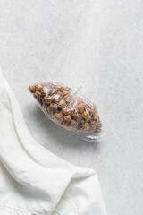 Overhead view of dried tiger nuts on a white bowl, top view of Yellow Nutsedge on a white background