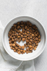 Overhead view of dried tiger nuts in a white bowl. top view of Yellow Nutsedge in a bowl