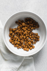 Overhead view of dried tiger nuts on a white countertop, top view of Yellow Nutsedge on a white background