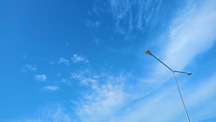 Blue sky with clouds and sun reflection.The sun shines bright in the daytime