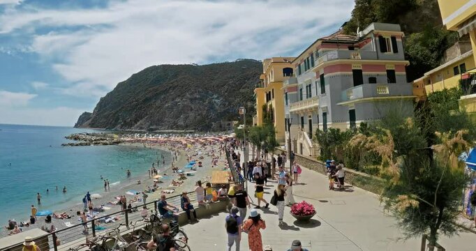 Hyperlapse of tourists enjoying a sunny summer day sightseeing at Monterosso Al Mare promenade