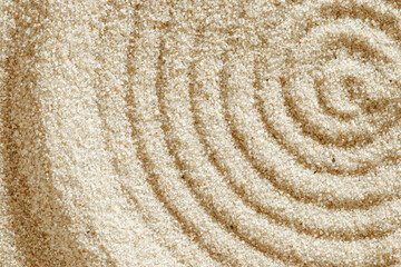 Top view pattern in Japanese Zen Garden with close up concentric circles on sand for meditation and relaxation. Aesthetic minimal sandy background with copy space, beige monochrome neutral tones