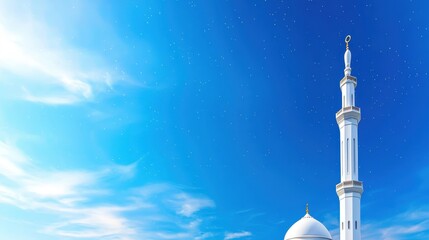 White mosque minaret reaching toward a vibrant blue sky
