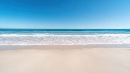 Fototapeta premium tranquil beach with clear blue sky and gentle waves lapping at shore