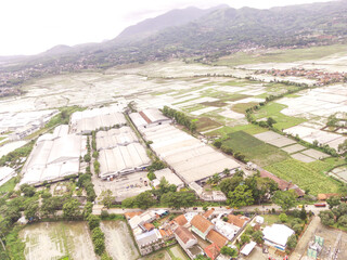 Cicalengka, Indonesia. Idyllic village scene, aerial view of countryside, paths and agricultural...