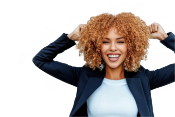 Joyful woman with curly hair celebrating success outdoors, expressing happiness and confidence