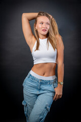 Blonde Woman in Sleeveless White Shirt and Blue Jeans