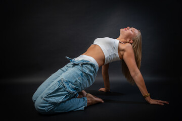 Blonde Woman in Sleeveless White Shirt and Blue Jeans