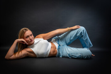 Blonde Woman in Sleeveless White Shirt and Blue Jeans