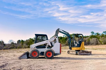 Fotobehang Vrachtwagen Compact Construction Equipment on a Worksite  © Our Creative Lab