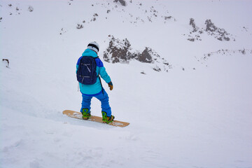 Snowboarder Descends a Snow-Covered Slope