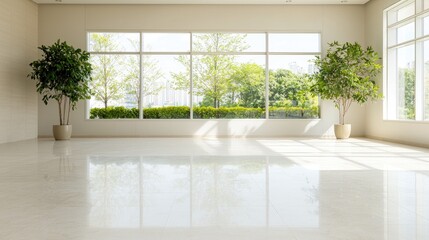 Fototapeta premium Empty modern room features large windows overlooking green trees in bright daylight.