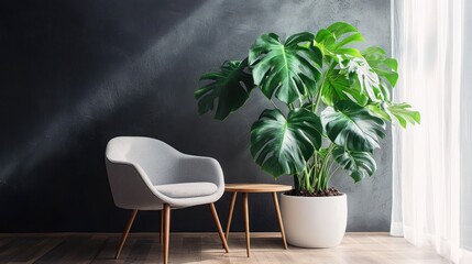 A smooth, dark gray wall with a small white window on the right side of it and an armchair in front of it. A table stands next to the chair. On top is a monstera plant.