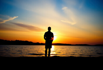 Fototapeta premium A man stands at the edge of a calm lake, casting a silhouette against the colorful hues of a breathtaking sunset.