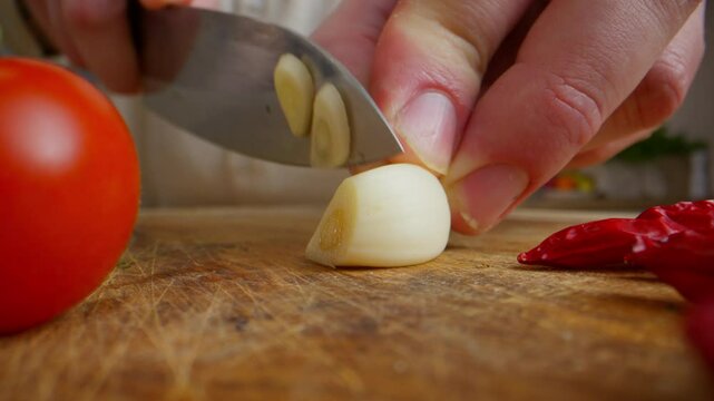 A chef chops a garlic