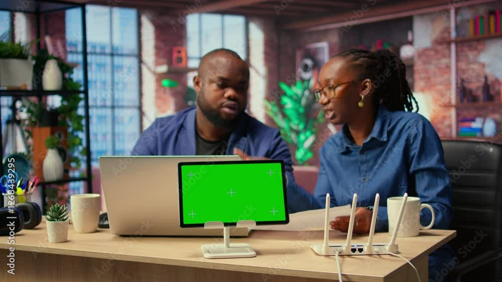 Poster african american couple browse troubleshooting guide next to chroma key, working together to debug r