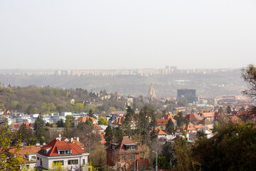 Obraz premium cityscape with many houses and trees under a clear sky.