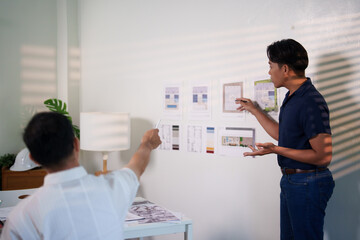 A group of engineers reviewing structural designs and material specifications at a meeting table