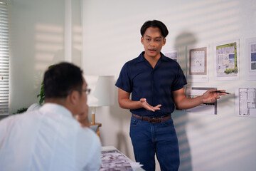 Fototapeta premium A group of engineers reviewing structural designs and material specifications at a meeting table