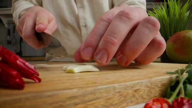 A chef cuts a garlic
