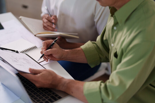 A professional engineering team working on cost estimation and resource allocation for a building project