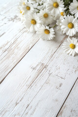 Obraz premium A beautiful arrangement of daisies on a rustic white wooden surface, evoking a fresh and cheerful atmosphere.