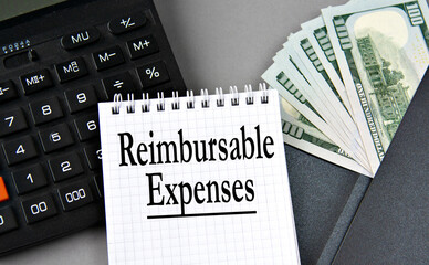 REIMBURSABLE EXPENSES - words on white paper on gray background with calculator and money notes