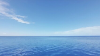 Obraz premium a clear day with blue skies and sea waves near the edge of the ocean on a sunny day