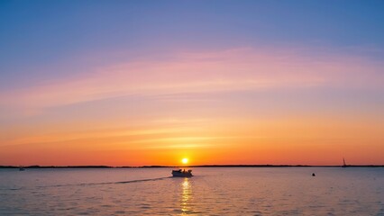 the sun sets over a body of water on a clear day and boats floating in the water