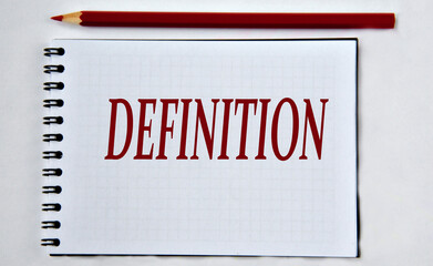 DEFINITION - word in notebook on white background with pencils