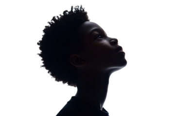 Silhouette of a young boy looking up