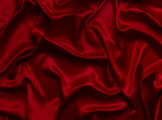 The top view of the red satin surface looks luxurious and beautiful. with sparkling waves Abstract background design copy space Card or banner (blurred or blurry)