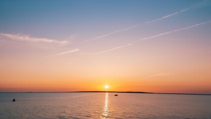the sun sets over a body of water on a clear day and boats floating in the water
