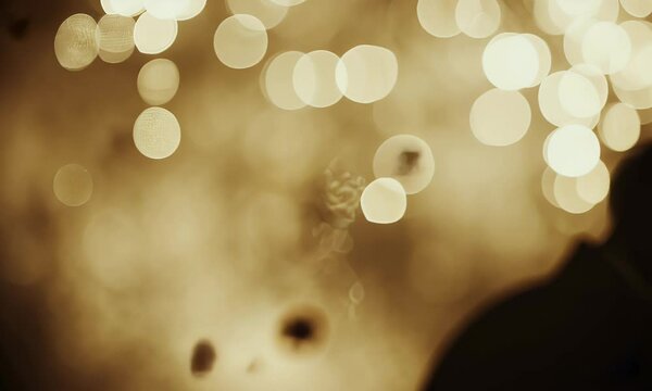Golden bokeh lights creating a warm and dreamy abstract background. Perfect for festive, romantic, cinematic, and artistic visuals
